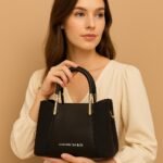 Elegant Ladies Faux Leather Handbag with Gold Accents and Logo